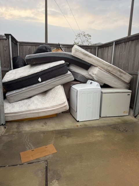 Bulk trash removal including mattresses and appliances at apartment complex in Houston Texas
