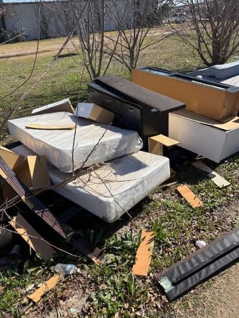 Illegal dumping of mattresses and furniture on apartment property in Pasadena Texas cleanup service near Houston