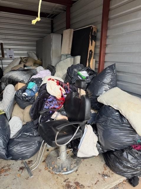 Before storage unit cleanout with furniture and bagged trash removal in Pearland Texas near Houston