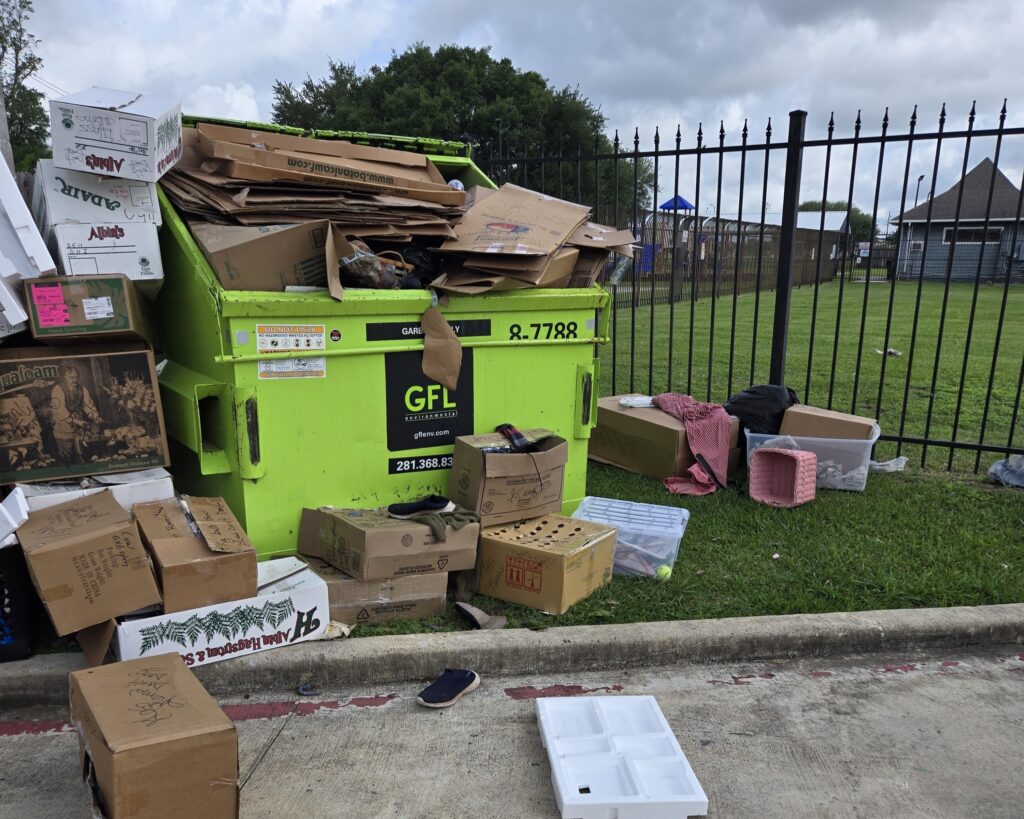 Apartment dumpster overflow cleanup with cardboard and trash removal in Katy Texas near Houston
