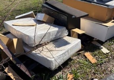 Illegal dumping of mattresses and furniture on apartment property in Pasadena Texas cleanup service near Houston